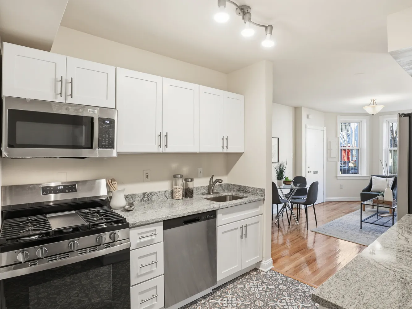 a kitchen with a stove a sink and a microwave