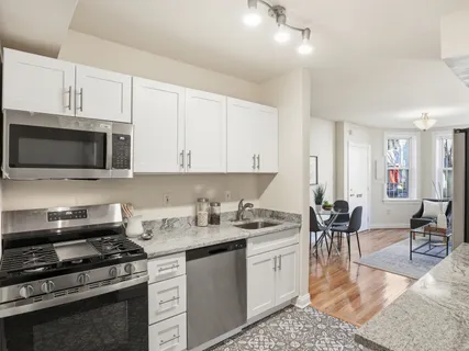 a kitchen with a stove a sink and a microwave