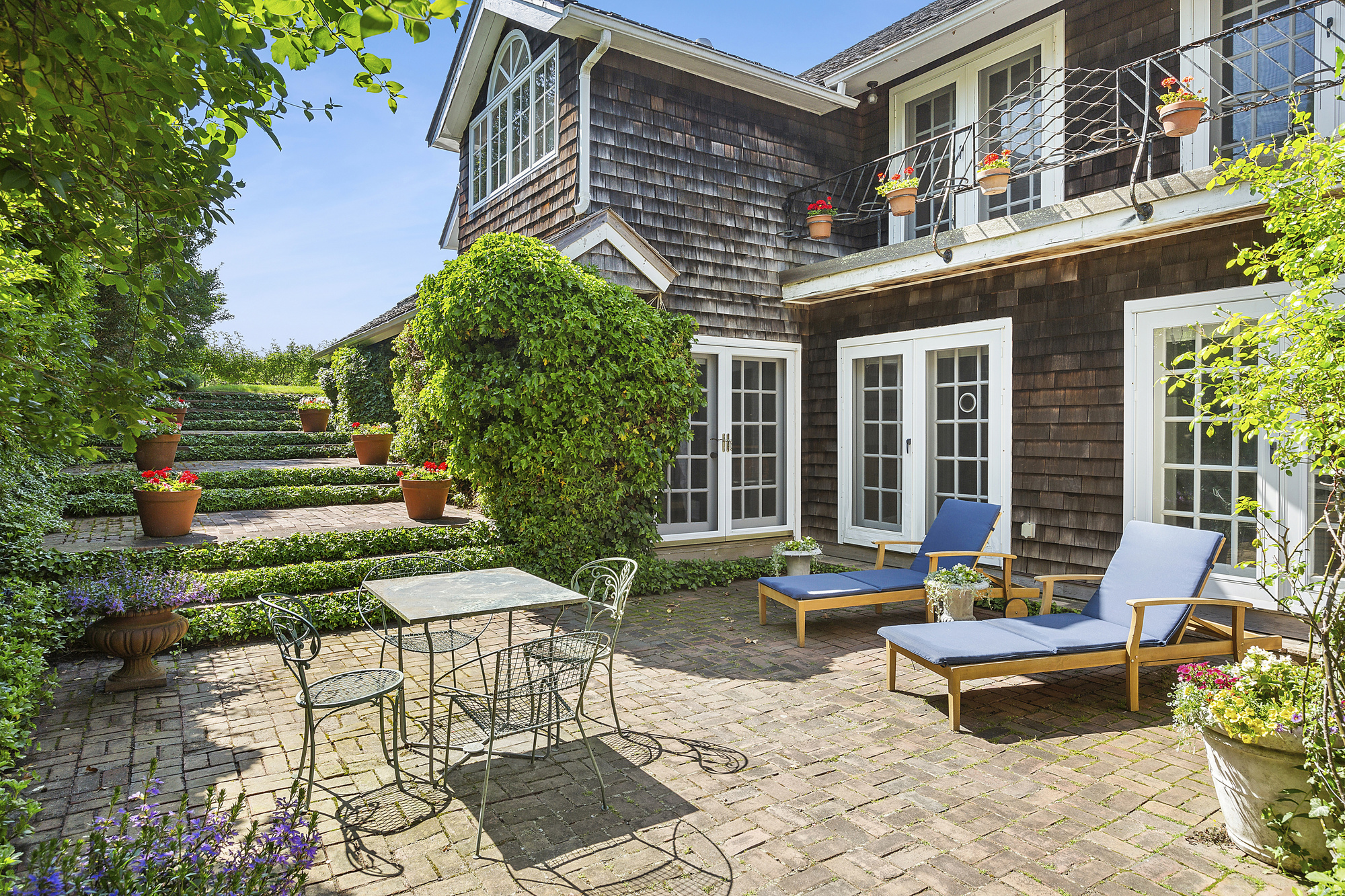 488 Ocean Road Bridgehampton, NY 11932 - Photo 12 of 21 a backyard of a house with outdoor seating