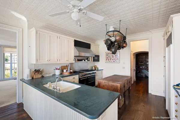 a kitchen with stainless steel appliances granite countertop a sink dishwasher a stove top oven a refrigerator with island and chairs