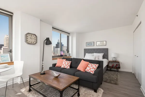 a living room with furniture and a wooden floor
