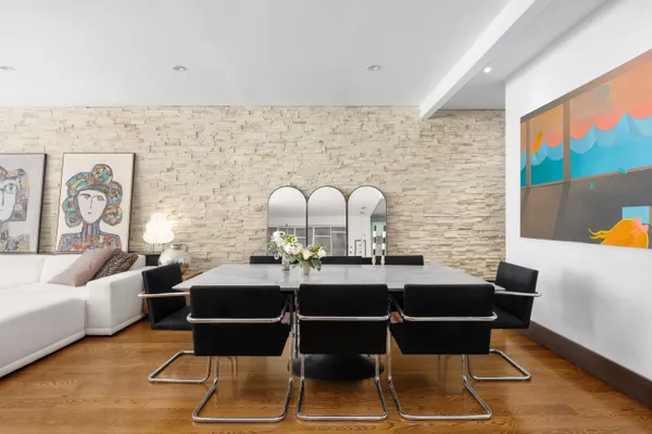 a living room with couches chairs and a coffee table with wooden floor