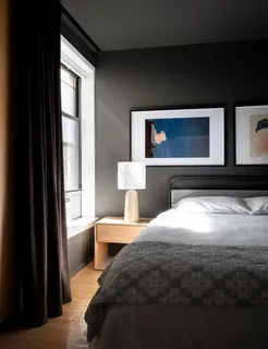 a bedroom with a bed and a potted plant