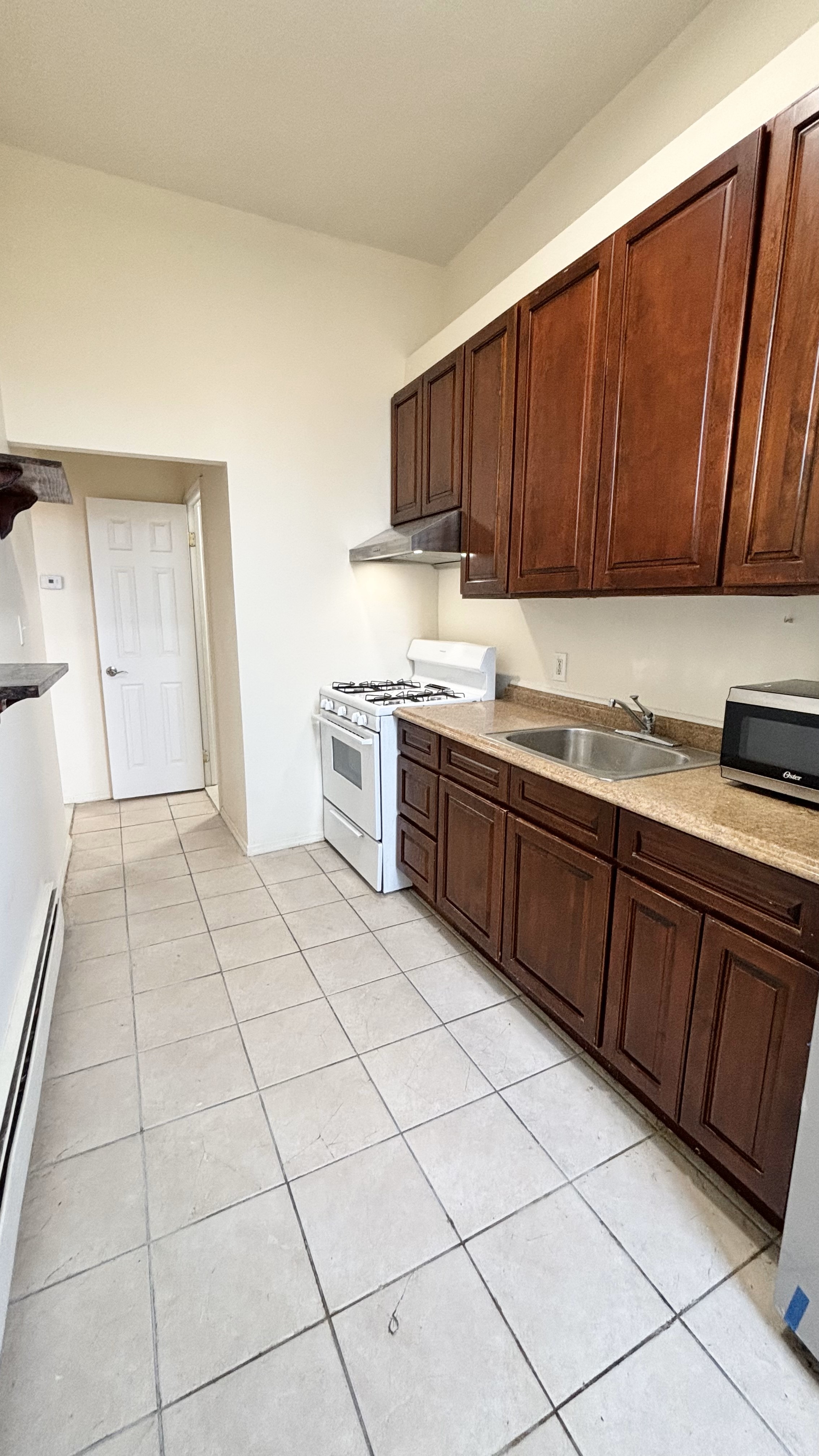 74 Himrod Street, Unit 2 Brooklyn, NY 11221 - Photo 14 of 16 a kitchen with stainless steel appliances a sink dishwasher stove and cabinets