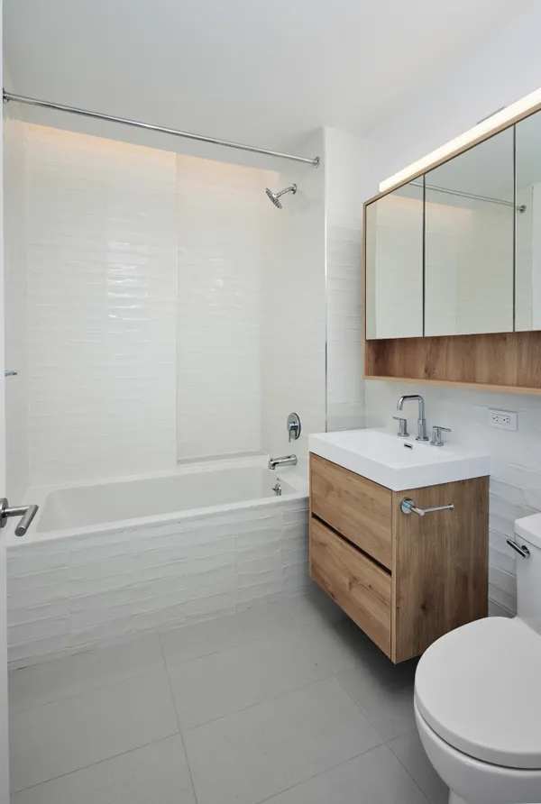 a bathroom with a white sink a toilet a shower and a bathtub