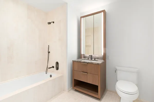 a bathroom with a granite countertop toilet a sink and bathtub