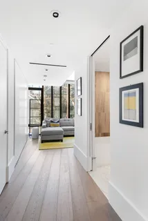 a view of a room with wooden floor and furniture