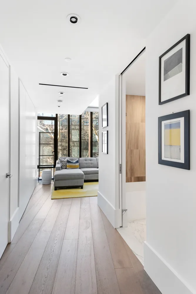 a view of a room with wooden floor and furniture