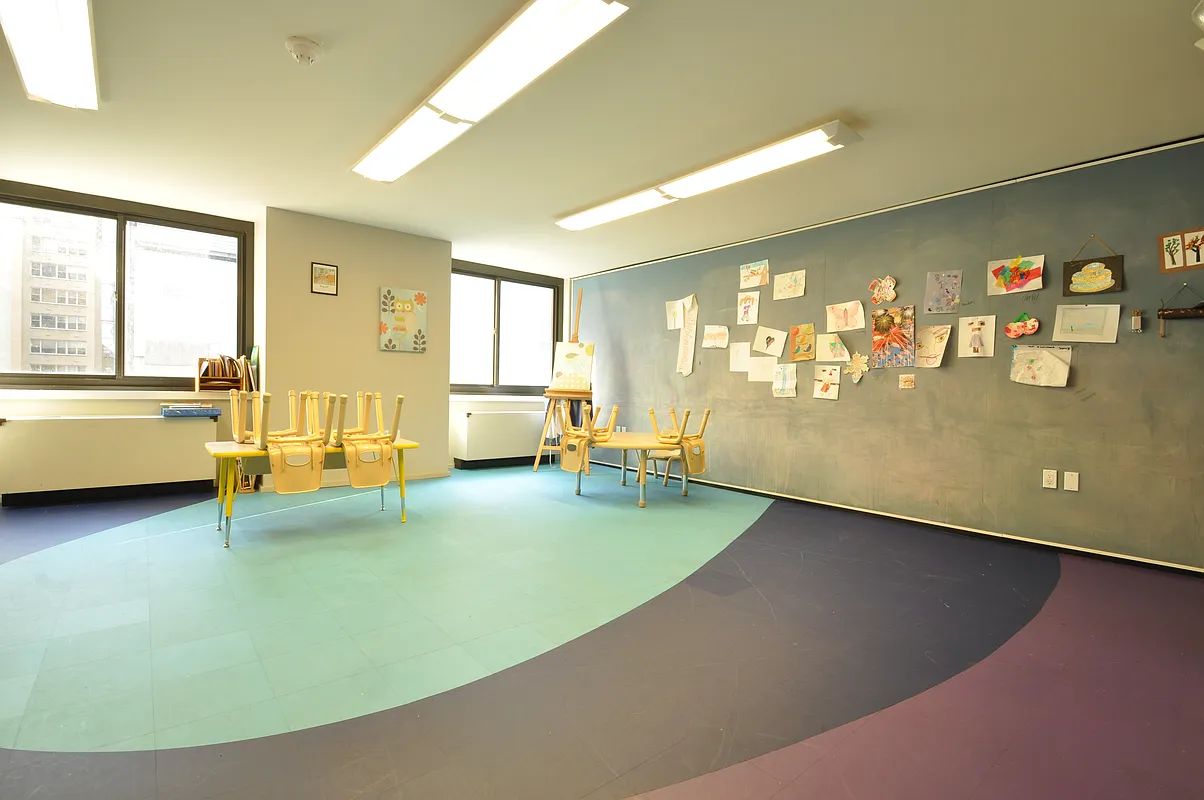 a view of a livingroom with furniture cabinet and windows