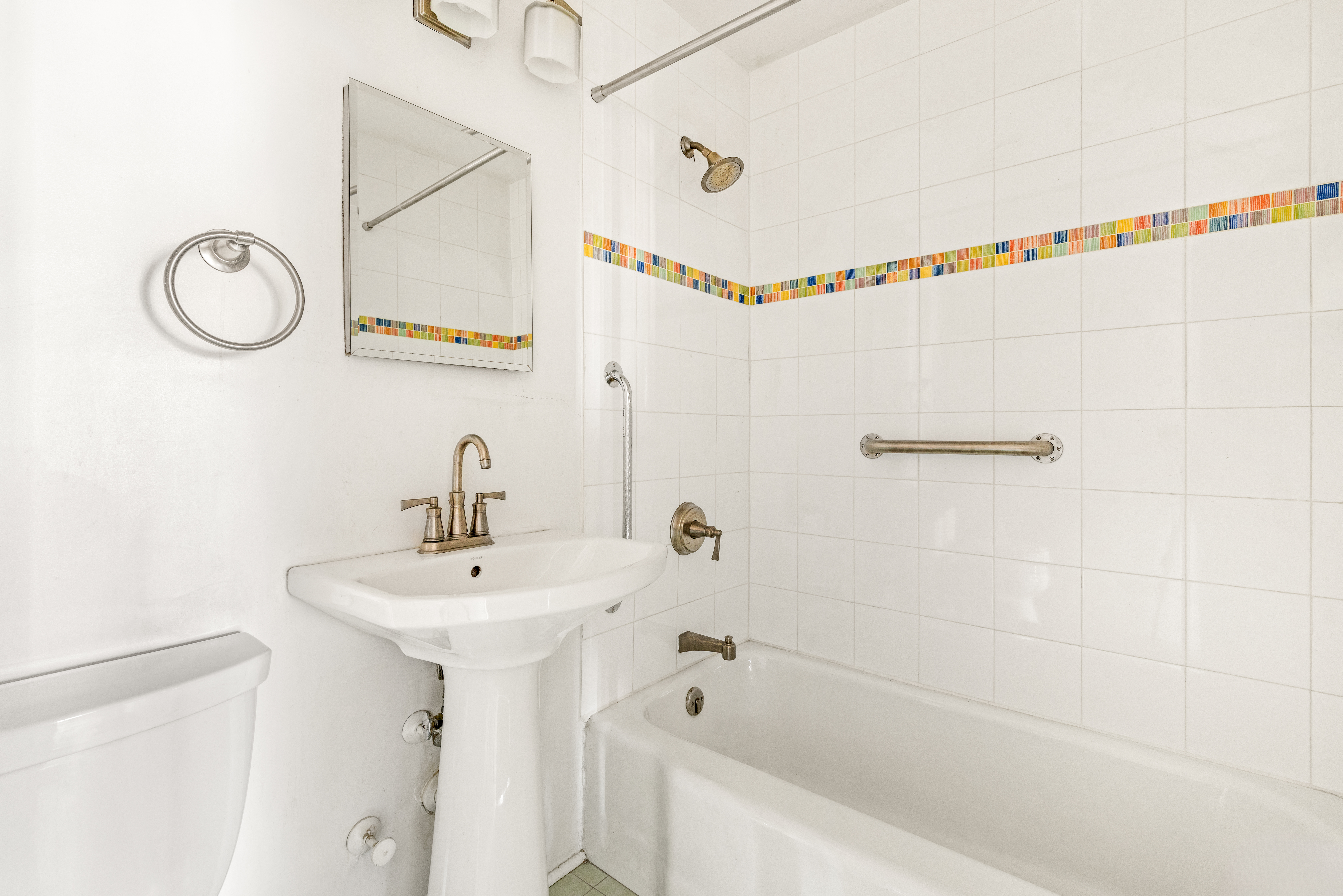 301 East 75th Street, Unit 14J Manhattan, NY 10021 - Photo 4 of 8 a bathroom with a bathtub a sink and a mirror