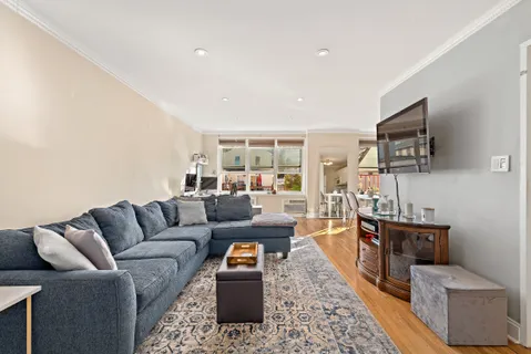 a living room with furniture wooden floor and a flat screen tv
