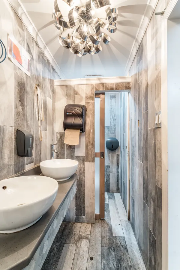 a bathroom with a double vanity sink mirror and shower
