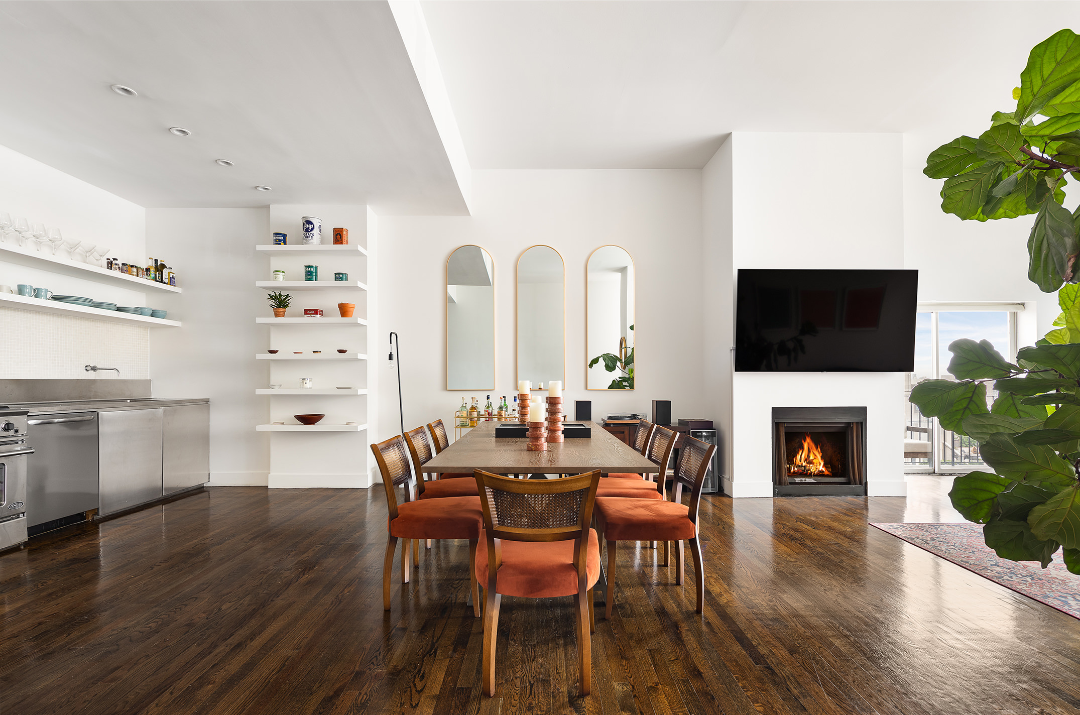 114 East 13th Street, Unit PHA Manhattan, NY 10003 - Photo 2 of 8 a view of a dining room with furniture window and wooden floor