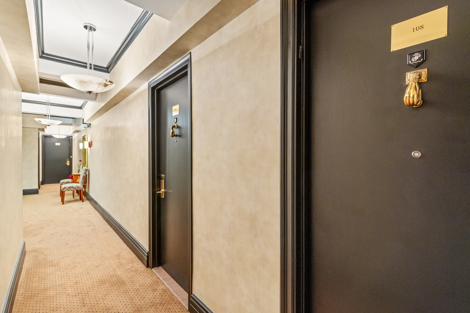 a hallway with wooden floor and stairs