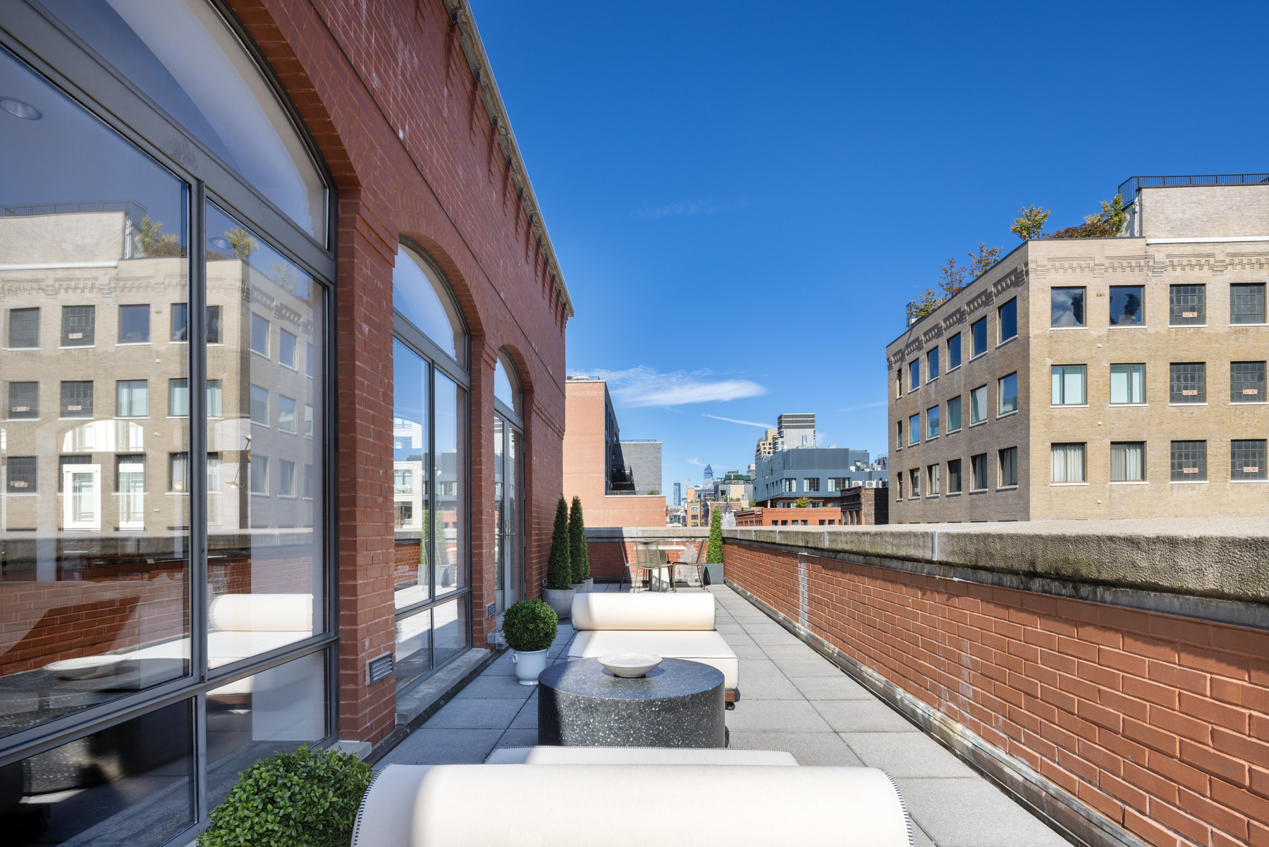 92 Laight Street, Unit PHC Manhattan, NY 10013 - Photo 15 of 16 a large building with a table and chairs