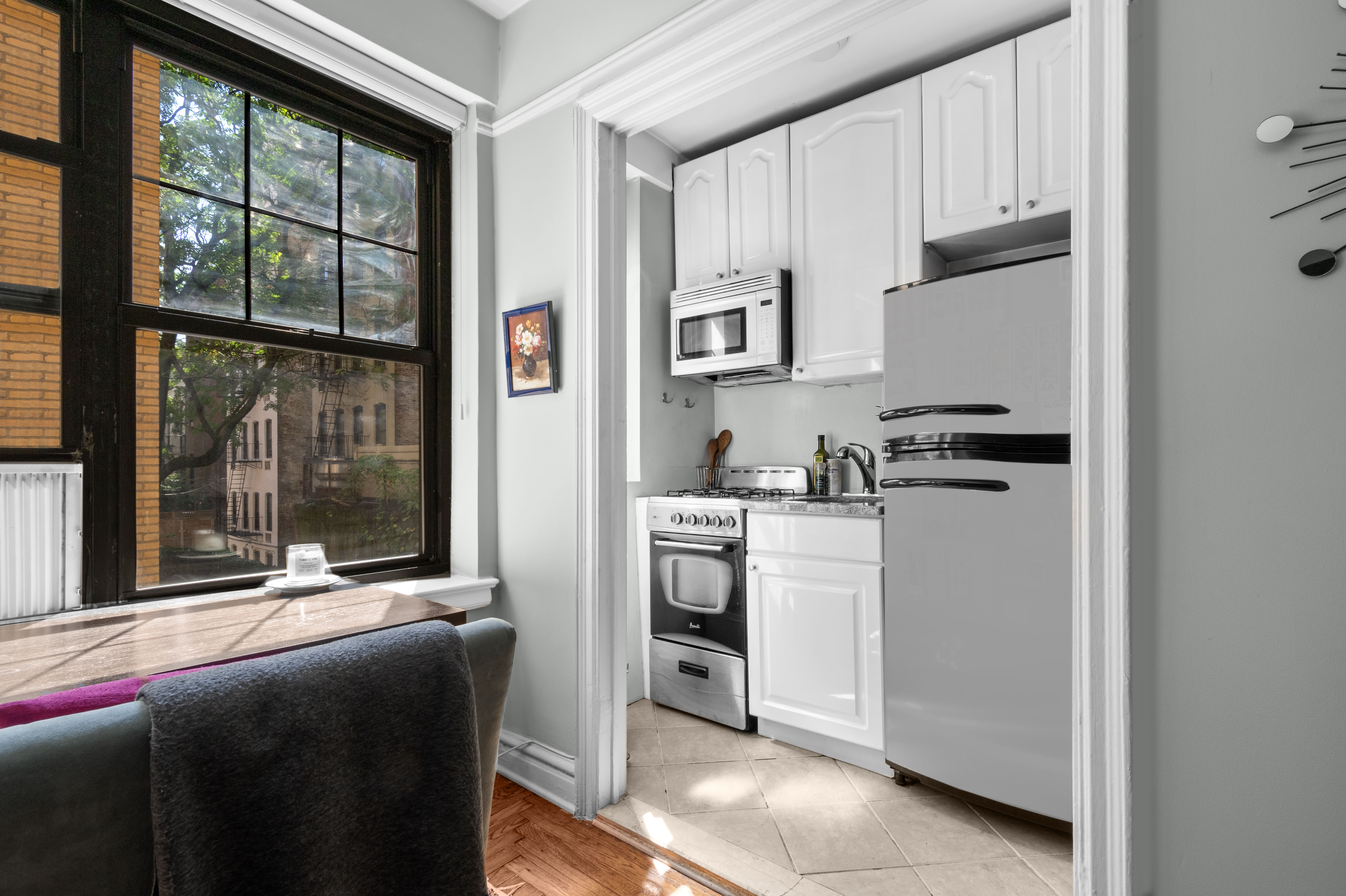 200 East 16th Street, Unit 2M Manhattan, NY 10003 - Photo 2 of 11 a kitchen with cabinets and a refrigerator