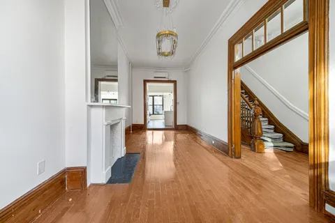 a view of an entryway with wooden floor and door