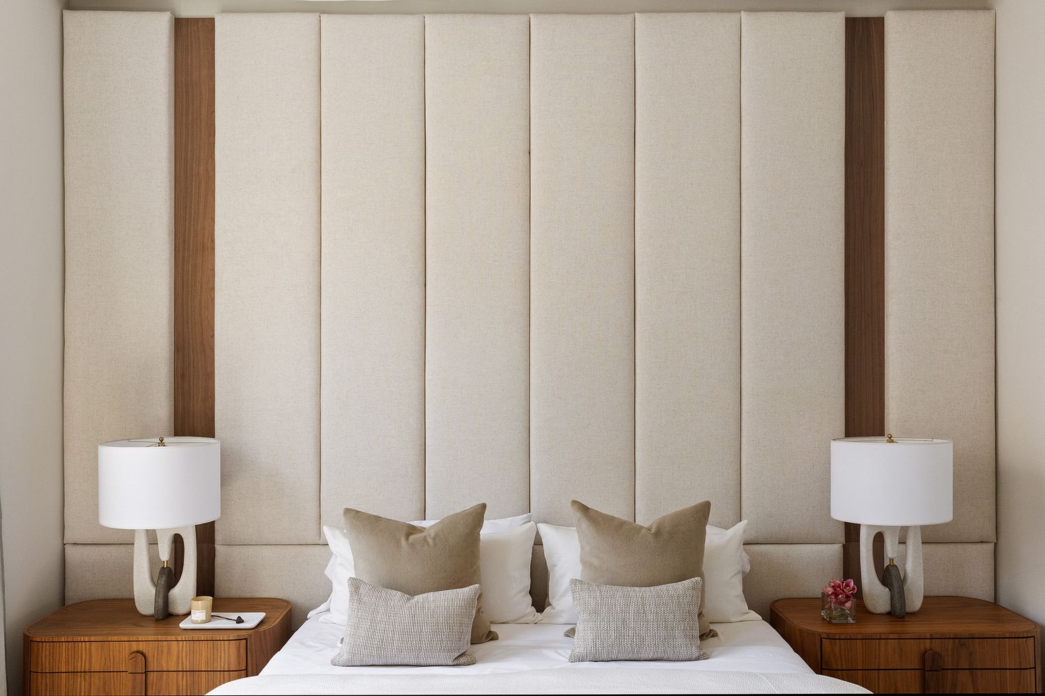 a spacious bedroom with a bed and a lamp on table