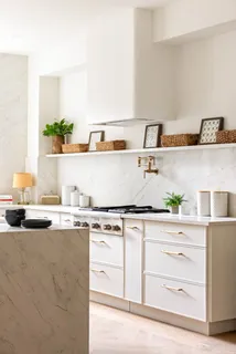 a kitchen with granite countertop a sink and a stove
