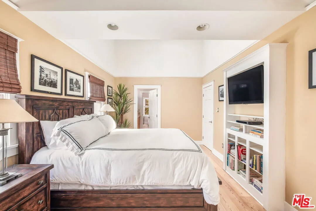 a bed room with a bed and a television