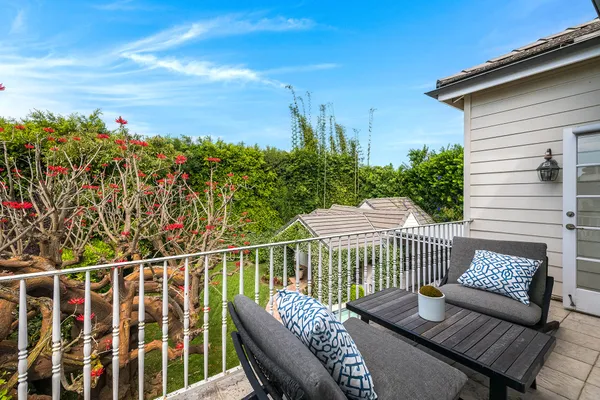 a view of a balcony with wooden floor