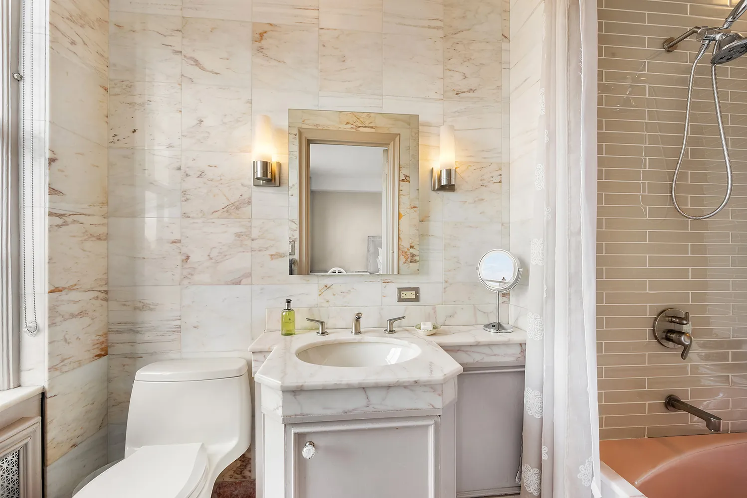 a bathroom with a sink toilet and shower