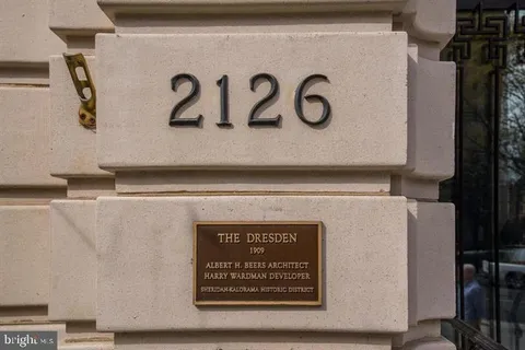 a dining room with furniture a fireplace and wooden floor
