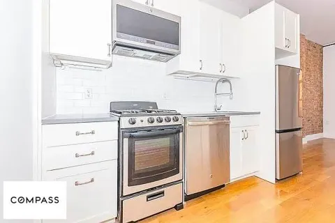 a kitchen with stainless steel appliances granite countertop a stove and a refrigerator