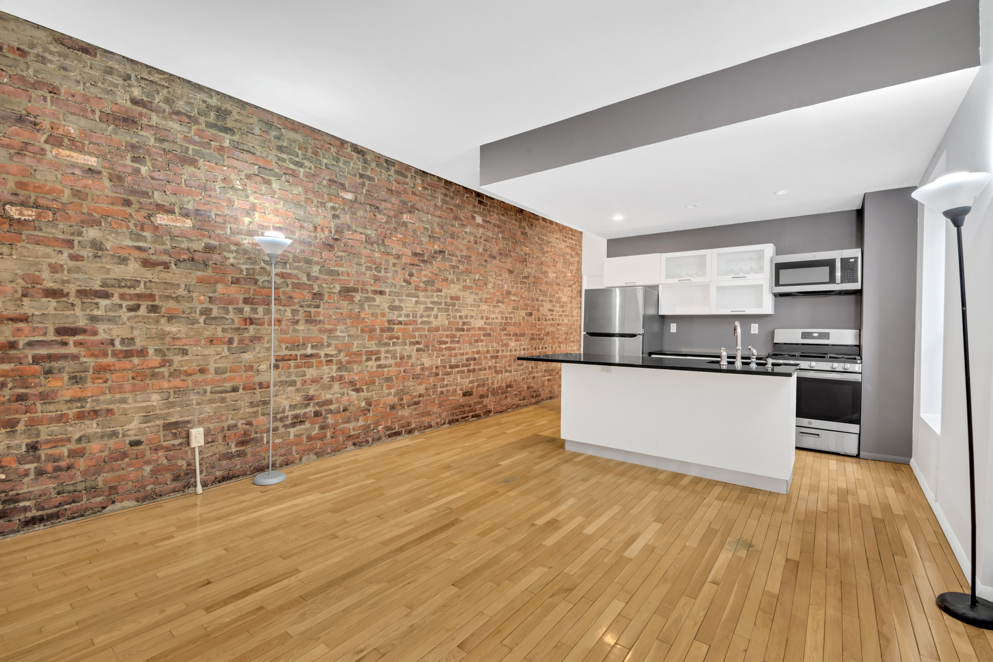 277 Nostrand Avenue, Unit 3A Brooklyn, NY 11216 - Photo 2 of 10 a kitchen with stainless steel appliances a refrigerator and a stove top oven