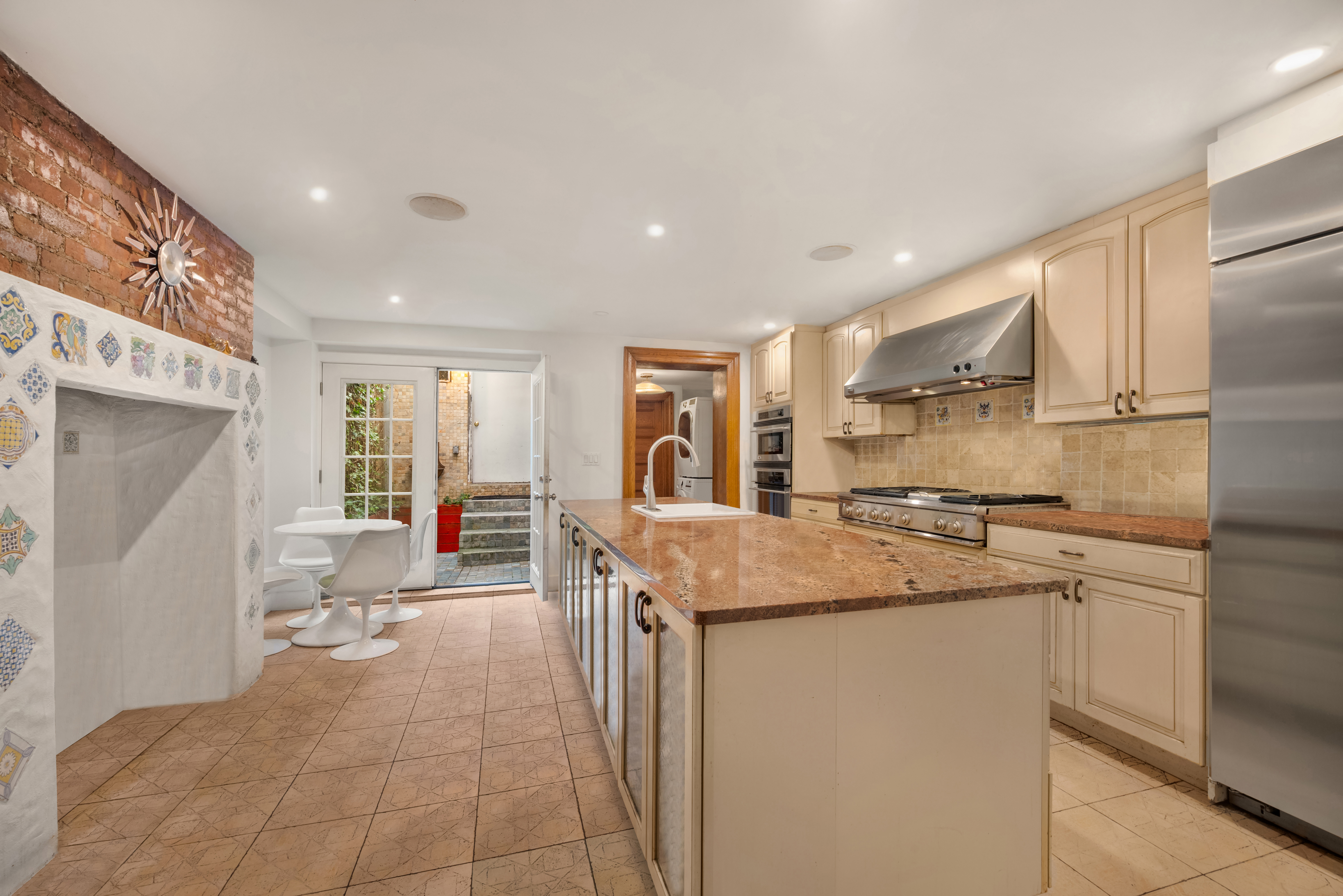 226 West 139th Street Boston, NY 10030 - Photo 4 of 14 a kitchen with stainless steel appliances granite countertop a sink a stove and a refrigerator