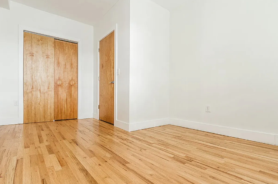 406 Monroe Street, Unit 3 Brooklyn, NY 11221 - Photo 5 of 11 a view of an empty room with wooden floor