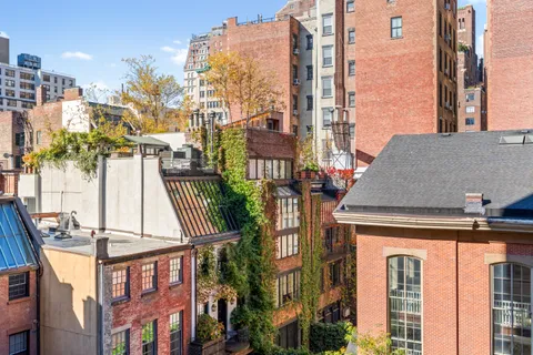 a front view of a residential apartment building with a yard