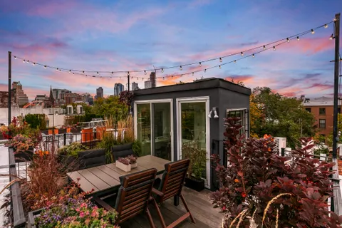 a view of a patio with table and chairs and potted plants
