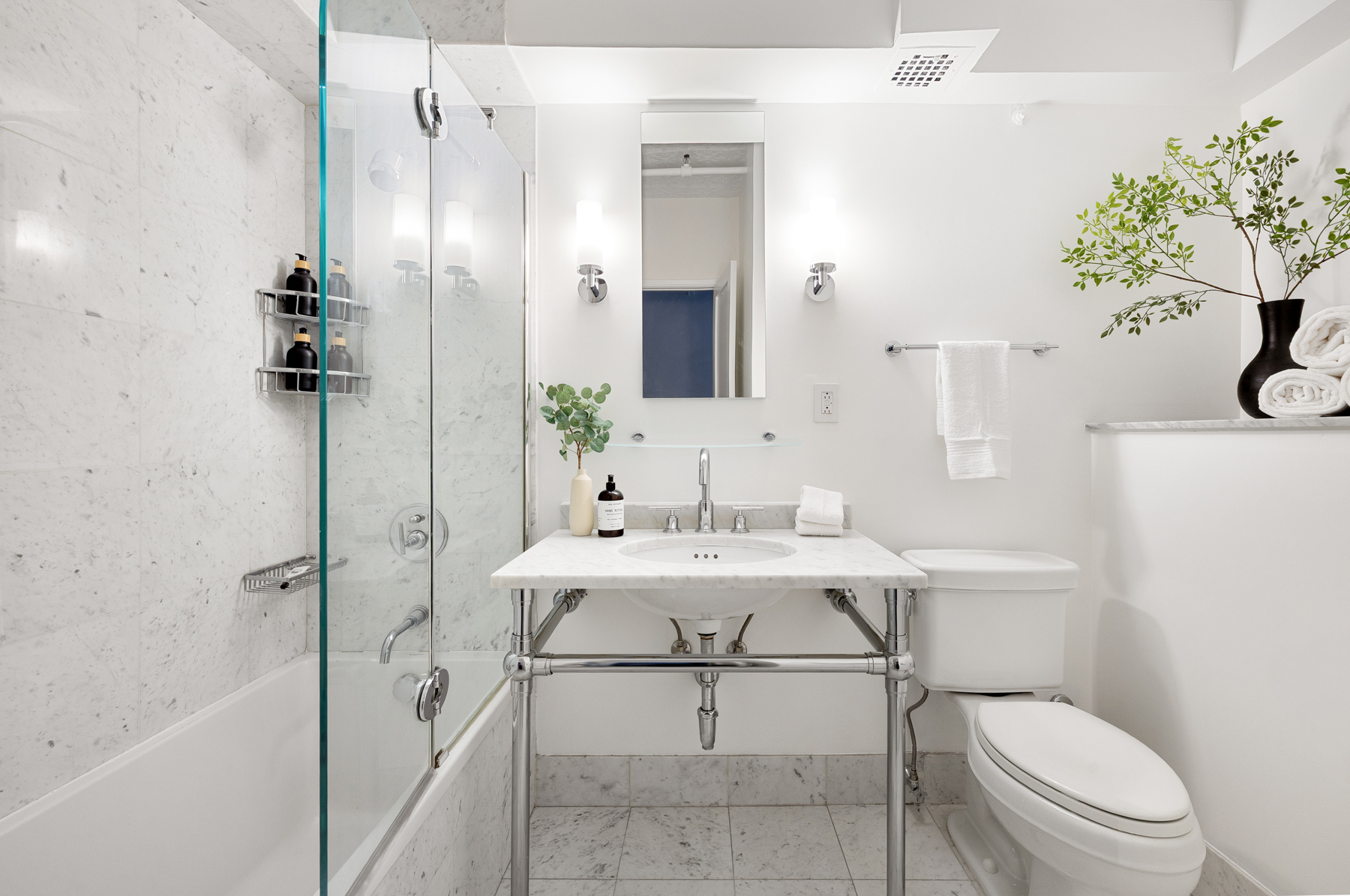 107 West 25th Street, Unit 5B Manhattan, NY 10001 - Photo 9 of 16 a bathroom with a sink toilet and shower