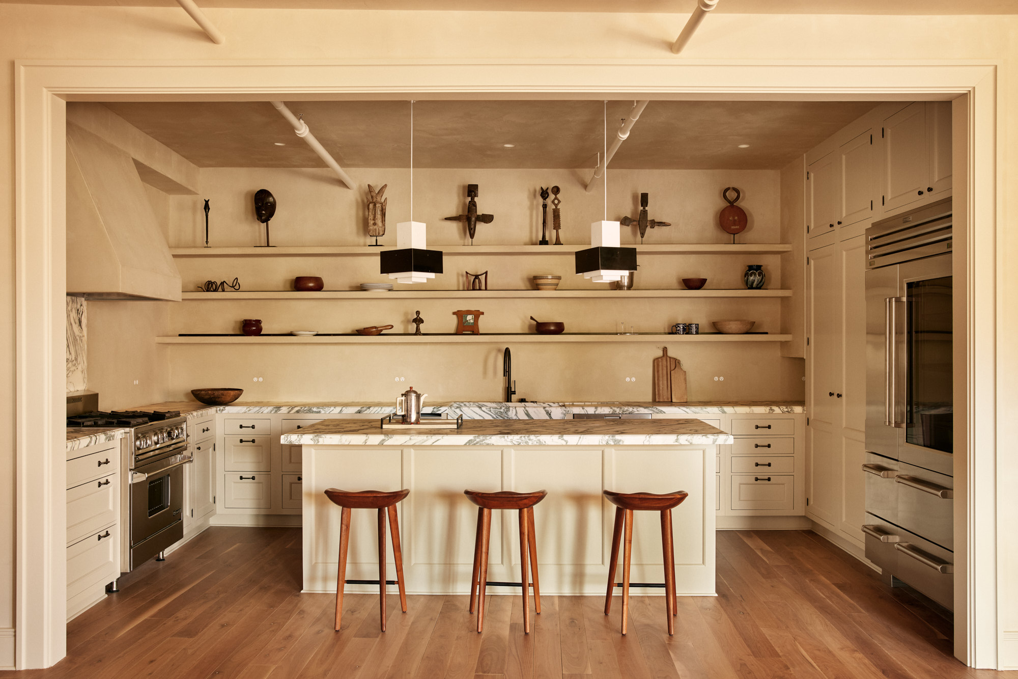 285 Lafayette Street, Unit 5D Manhattan, NY 10012 - Photo 6 of 22 a kitchen with a table chairs stove and cabinets
