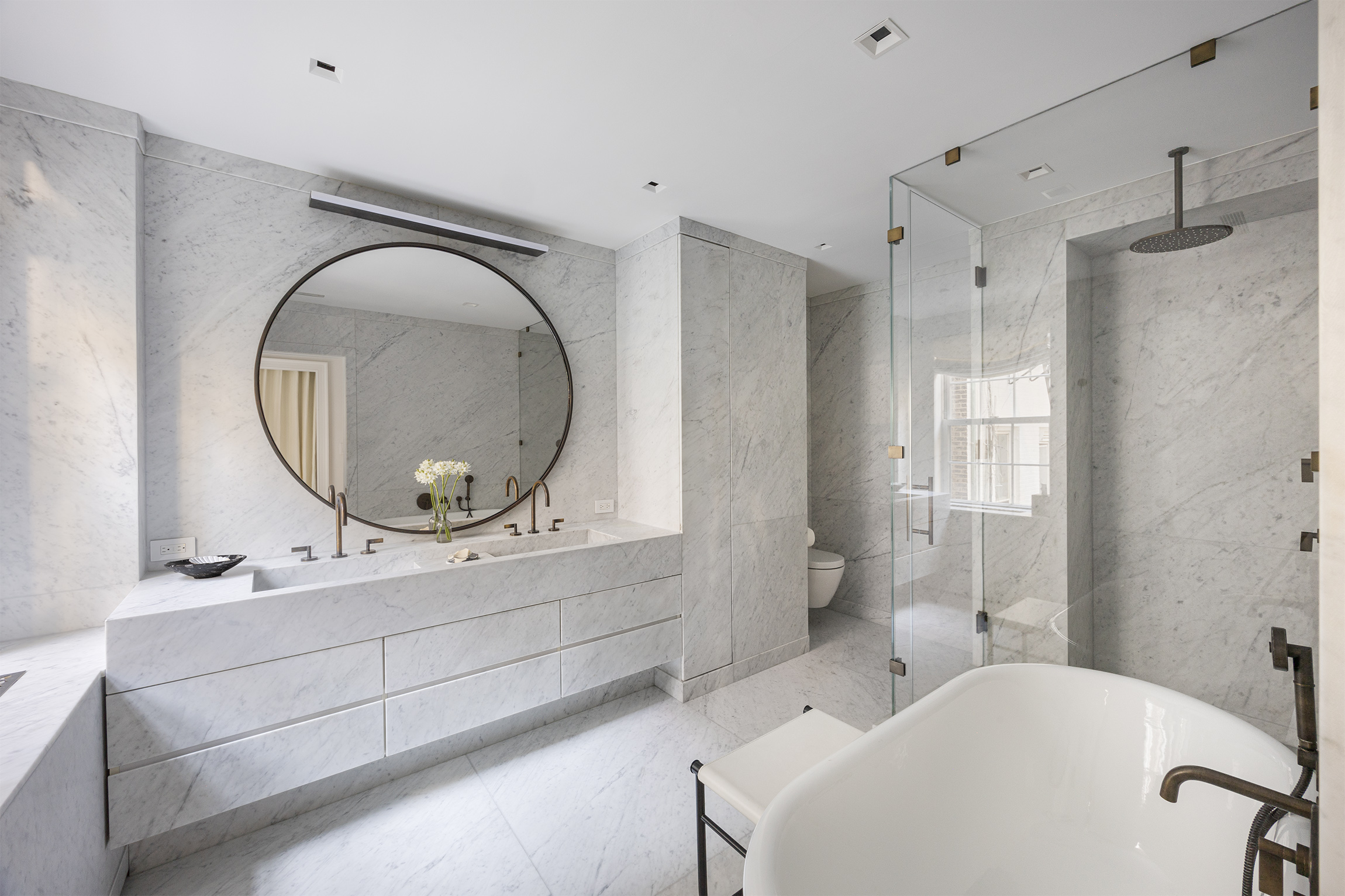 133 East 64th Street, Unit 2B Manhattan, NY 10065 - Photo 9 of 14 a bathroom with a sink mirror vanity and toilet