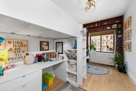a bedroom with furniture and a wooden floor