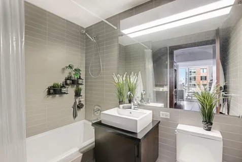 a bathroom with a sink a mirror and a bathtub