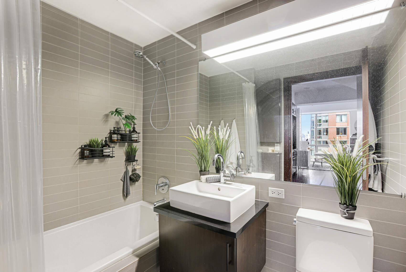 150 Myrtle Avenue, Unit 2302 Brooklyn, NY 11201 - Photo 9 of 28 a bathroom with a sink a mirror and a bathtub
