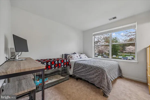 a bedroom with a bed and window