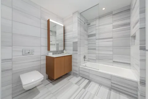 a bathroom with a sink a toilet and bathtub