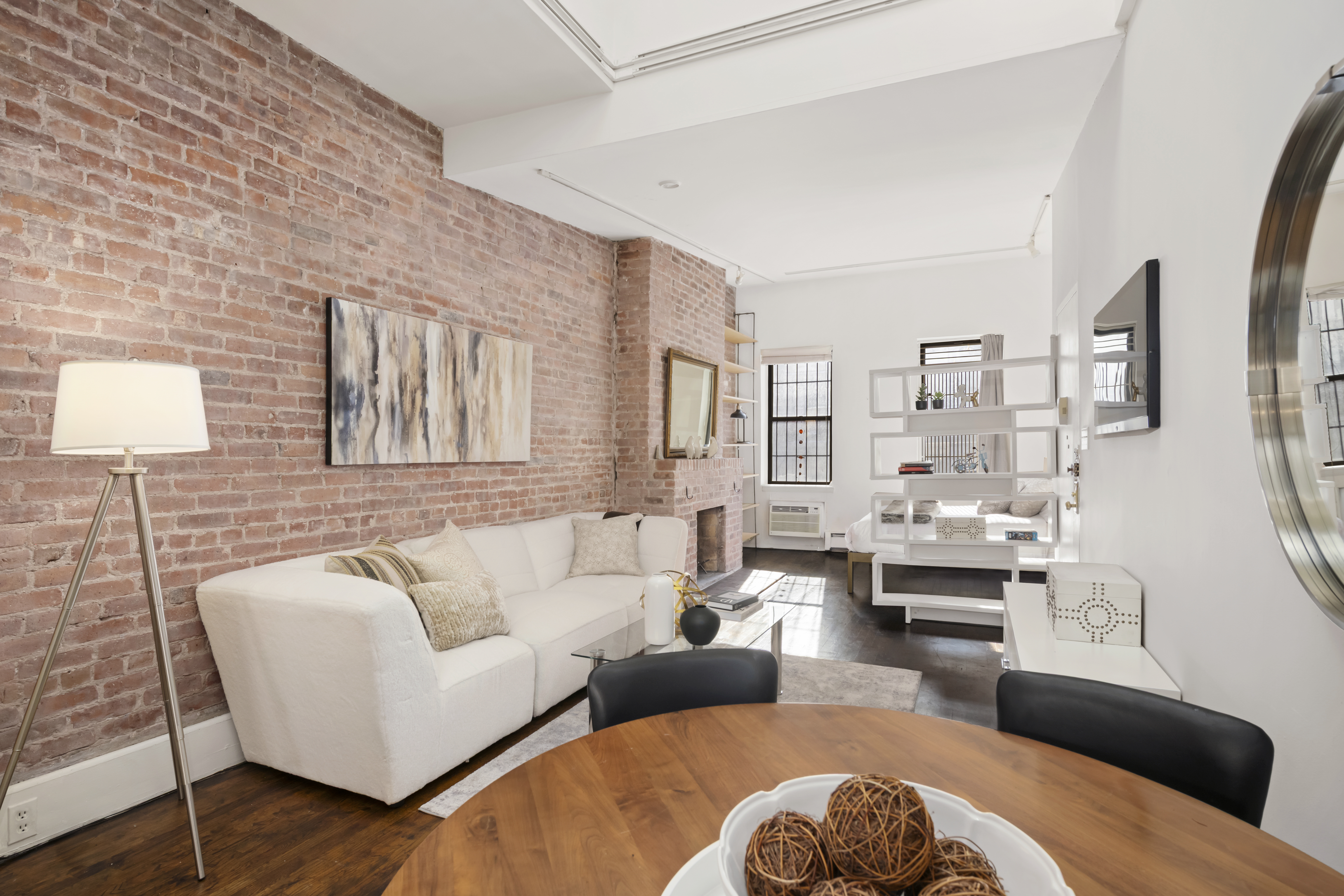 351 West 53rd Street, Unit 4E Manhattan, NY 10019 - Photo 4 of 9 a living room with furniture and a wooden floor