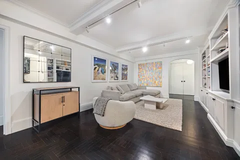 a living room with fireplace furniture and a flat screen tv