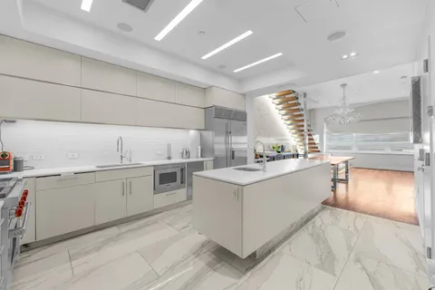 a kitchen with a sink stove and cabinets