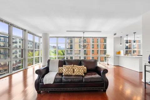 a view of empty room with wooden floor and windows