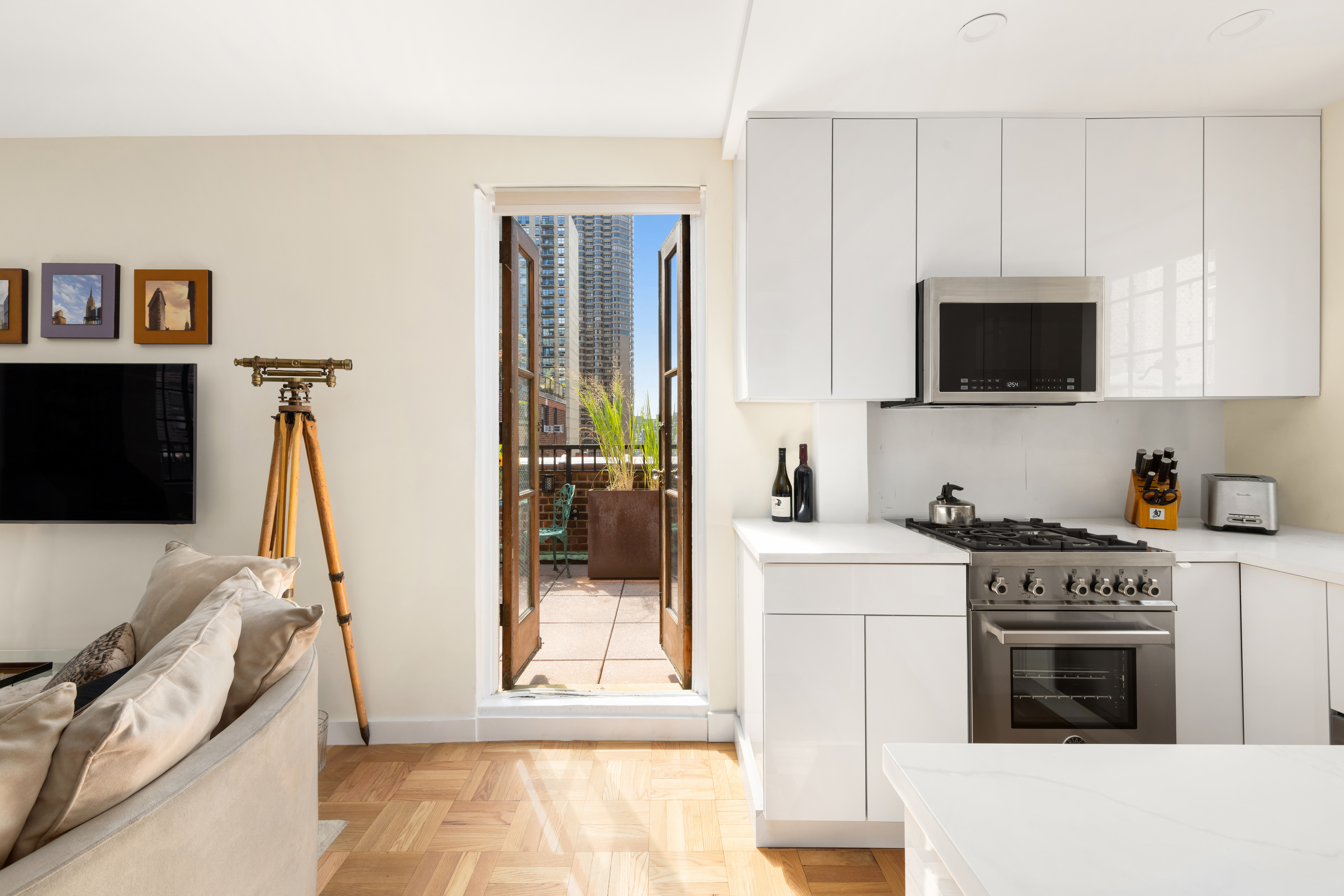 324 East 41st Street, Unit 1103C Manhattan, NY 10017 - Photo 6 of 13 a kitchen with a stove and a microwave
