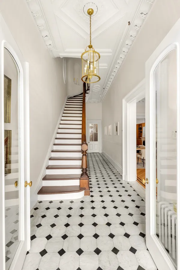 a view of a hallway with windows and stairs