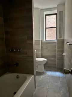 a bathroom with a bathtub and toilet
