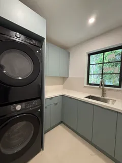 a utility room with sink dryer and washer