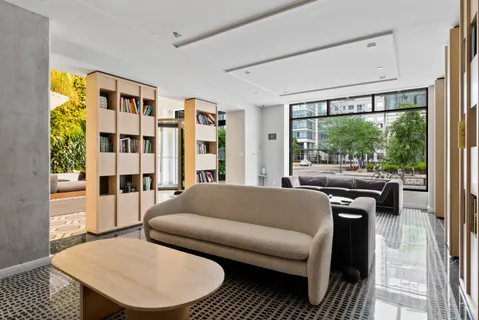a living room with furniture and a floor to ceiling window
